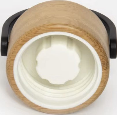 Close-up of the underside of the SaunaPlunge bottle's wood-finish lid