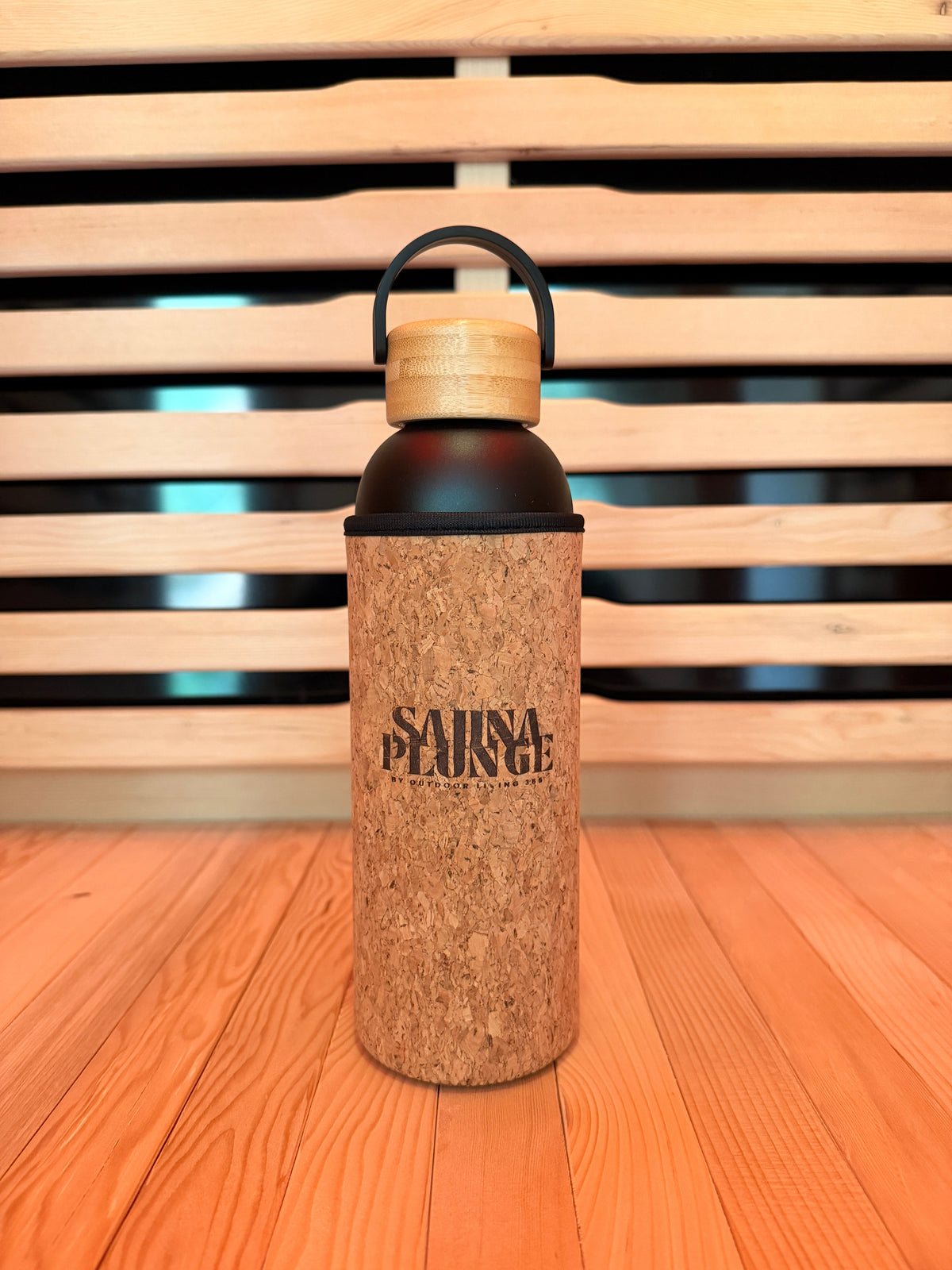 SaunaPlunge cork-covered bottle on a wooden sauna bench